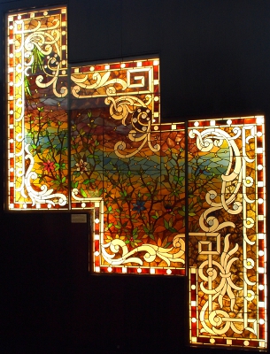 [A stepped designed stained glass winodw with several panels creating an overall design.]